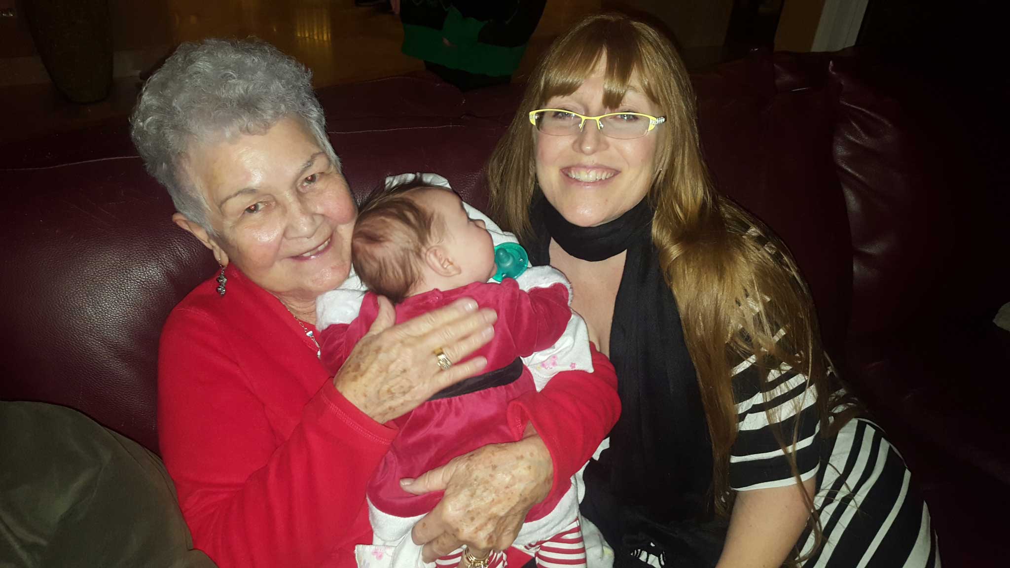 Grandmother, mother and baby sharing stories