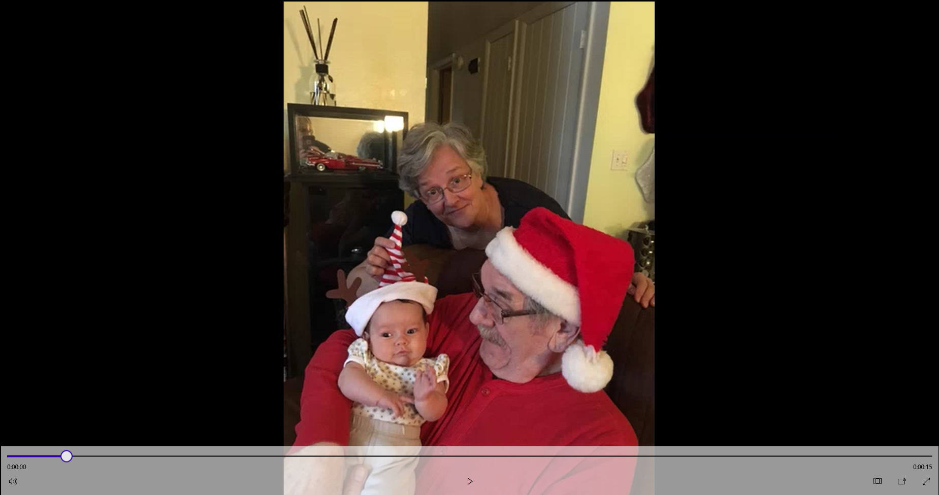 Grandma and Grandpa hold grandbaby and everyone is wearing Christmas clothes!